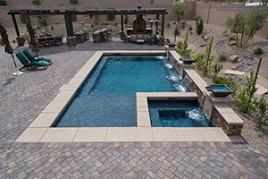 Rocky and rustic, a beautiful combination to enhance any pool. Multiple scuppers spill into this rectangular Las Vegas pool finished in NPT's ColorScapes St. Martin Shade.