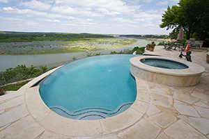 When fortune favors you with a view this captivating, a vanishing edge pool is the only way to go! Note how the boundary lines fade where the NPT StoneScapes Aqua Cool Mini pool finish ends and is trimmed in a band of Jules Rustic Blue Blend tile.