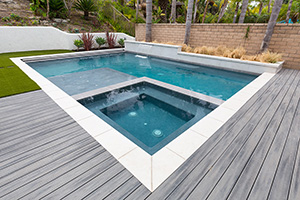 Simple, beautiful, and enjoyable. This modern pool brings simplicity to luxary with a built in spa and water scuppers on a raised beam.