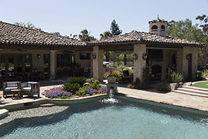 Take a step outside and breathe in the fresh air as you slip into a Spaniard style pool with water scuppers and vibrant greenery. Have a vacation in your own backyard.