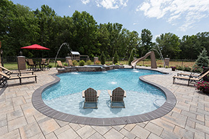 Have some fun in the sun with a pool like this! With a water slide for kids, a tanning ledge for parents and a hot tub for friends, this pool is perfect for everyone!