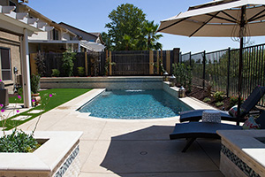 The contrast of green and blue screams unlimted fun in this suburban backyard. Small additions like lounge chairs, laterns, greenary, and water scuppers can make your backyard appear bigger than before.