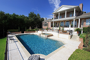 Sometimes a simple, elegant pool is the perfect match for a home. This beautiful backyard is form-fitted around the attached spa of this gorgeous Grecian pool finished in StoneScapes Tahoe Blue with Abalone.