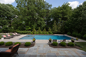 Finished in NPT ColorScapes Bora Bora Blue, this picturesque Pennsylvania poolscape is the focal point of the forest.