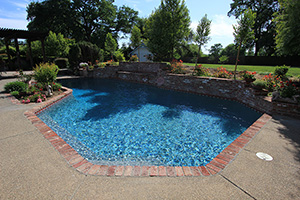 Geometric pools have a reputation for formality, but that doesn’t always have to be the case. This California homeowner kept the angular elegance but softened the overall feel with red brick coping and lush landscaping. Giving a rustic and homey feeling to their backyard design.