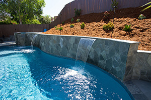 Sheer Descent Cascades create beautiful water effects and a variable amount of motion from silent and serene to rushing waterfalls. This cascade pair accents the 4ft raised wall and matches the spa overflow. The added movement helps the NPT StoneScapes Tahoe Blue Touch of Glass Puerto Rico Blend to glisten in the sun.