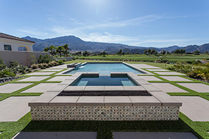 A stone's throw from the golf course, this rectangle pool features a raised spa skirted with NPT's Fusion Pinwheel tile and a custom StoneScapes finish.