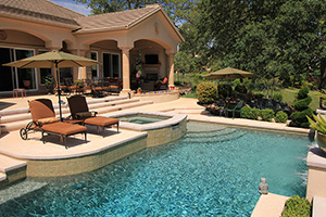 This sophisticated stunner in the California hills features an elegant raised bond beam with three sheer descents and cantilevered cement decking/coping.