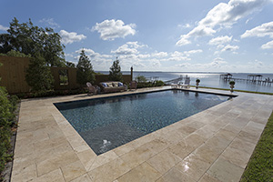 Are you going for a sparkle or sleek design in your pool? This luxurious riverside pool is surrounded by ivory travertine decking and features a custom aggregate Touch of Glass finish for an extra bit of shimmer.