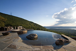 Be one with nature in this captivating pool. Every feature of this free-form mountain side pool evokes that carved-from-stone feel – including the beach entry with its rustic stone finish and boulders that mimic a natural forest pond.