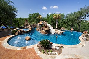 Welcome to the island of fun! This backyard paradise features swim paths, bubblers, slides, waterfalls, and more!