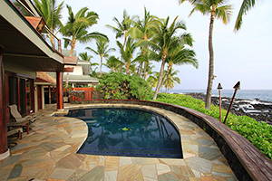 Say hello to the tropical paradise you can have in your own backyard! This beautiful rounded pool gleams with the sparkling trim of the tile on the steps,  inviting you to dive deeper into the dark waters of the  Quartscapes Midnight Blue pool finish.