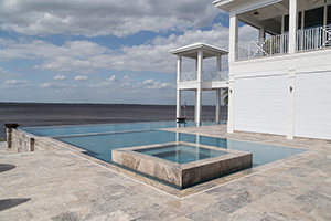 A sleek pool design and a beautiful view, what more could you ask for? The  marble coping against this Aztec tile creating a sublte dark outline that enhances the water color.