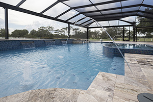 Laminar Jets and rows of scuppers flow into this amazing enclosed pool finished in NPT's PolishedScapes Breakwater Pool Finish and surrounded with Silver travertine decking.