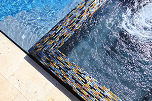 Many homeowners say the hardest decisions to make when building a pool involve choosing the materials. Interlocking tile, like this Blackies tile by NPT, add modern sophistication to any pool.