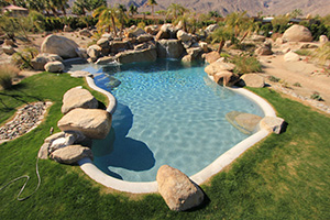 Get a natural lagoon with a rocky formation and bright sparkling waters using NPT's French Mini Grey pool finish. This freeform pool looks like something you would discover on a hiking adventure through the mountains.