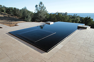 Love a modern poolscapes? This pool's intense, dramatic watercolor opens up to a mesmerizing waterfront view. The pool's rectangular shape,  mirror-like surface, inset spa and infinity edge contribute to its contemporary appearance.