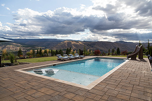 Rolling Northwestern mountains make the perfect backdrop for this classic rectangular pool finished using NPT QuartzScapes Super Blue. The light blue watercolor cools and refreshes.