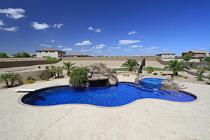 Don't mistake this opulent blue all-tile pool as a mirage. This is a true desert oasis, complete with spillover raised spa, large sun shelf and waterslide grotto! Achieve this look in your backyard with NPT Jules Bright Blue Blend pool tile.