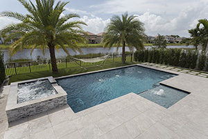 Picture yourself loungine poolside in this hammock, enjoying the warm sun and beautiful views. Sounds like paradise? Create your backyard escape with tropical features like NPT StoneScapes Aqua White Mini Pebble pool finish, a soothing spa and tanning ledge.