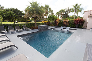 Staycation in style with a spool (small + pool) like this tropical Floridian backyard. Add a raised bond beam with water feature and lounge chairs to transform your backyard into a resort-style paradise.