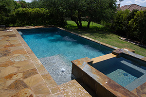 A fresh pool finish can breathe new life into an older pool. NPT StoneScapes Tahoe Blue finish produces a relaxing green-blue hue that complements the warm, natural-looking coping and decking.