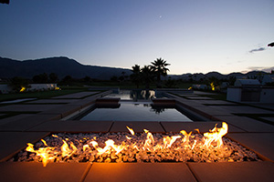 Want to give your poolscape an exciting look? Incorporate a linear fire pit like this gorgeous fire glass model. A strip of fire appears to emanate from the surrounding decking, creating a luxurious and unforgettable environment.