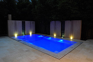 Looking to establish a formal feel in your outdoor space? Consider a strong, structured pool shape like rectangular or geometric. This San Diego homeowner dressed their pool in high-end elegance, with a wall-to-wall marble tile pool finish and sandstone and marble accents.