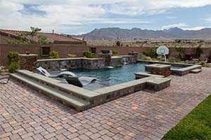 The perfect pool for family fun, this pool features a sun shelf with loungers that looks over the built-in basketball goal for perfectly safe summer fun.