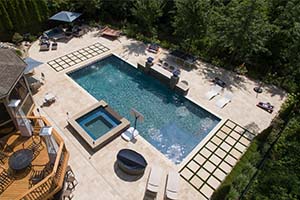 The landscaping and pavers make this pool pop with aesthetically pleasing angles and a raised attached spa.